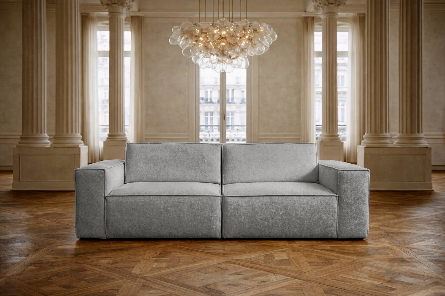 Canapé droit Beaux Arts de Paname Avenue dans un salon haussmannien  luxueux avec lustre monumental